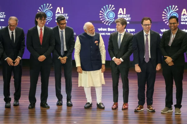 Indian Prime Minister Narendra Modi (center) takes a group photo with AI company leaders, including OpenAI CEO Sam Altman (third from right), Anthropic CEO Dario Amodei (second from right), Google CEO Sundar Pichai (third from left) and Meta Chief AI Officer Alexandr Wang (second from left), at the AI Impact Summit in New Delhi on Feb. 19. (Image: krvs)